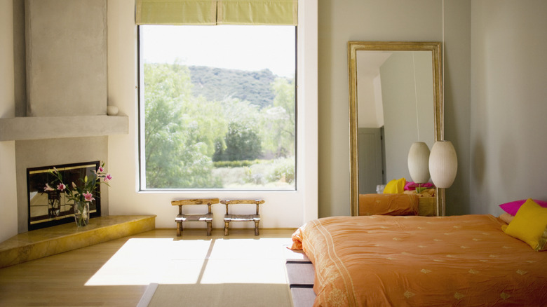 cozy bedroom with flowers in front of a fireplace