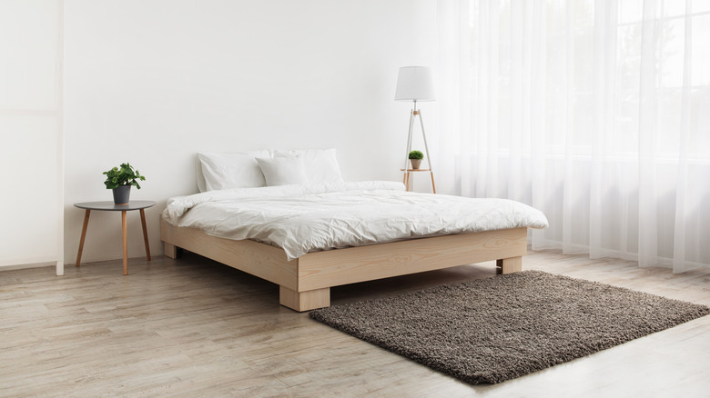 minimalist bright bedroom with low bed frame and minimal decorations