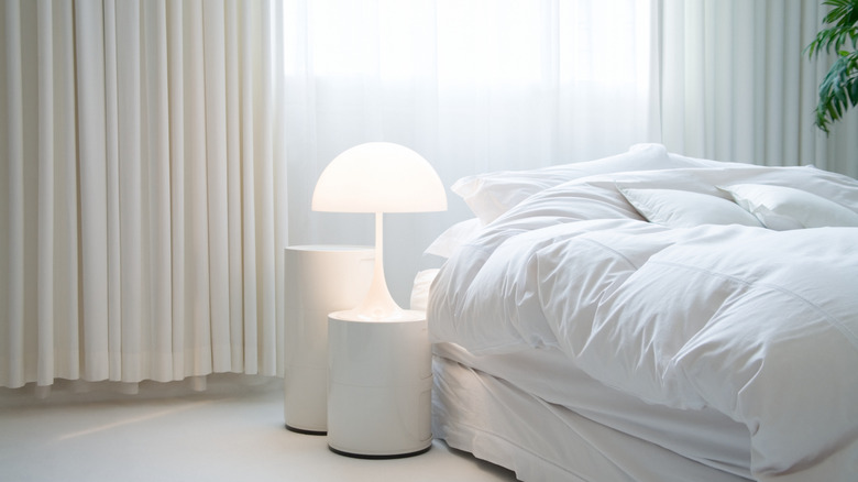 minimalist bed with contemporary white side table