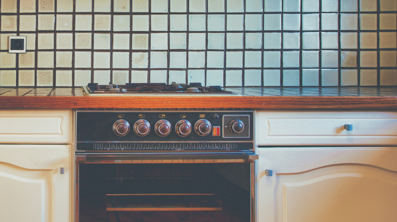 Dated kitchen with tile counters