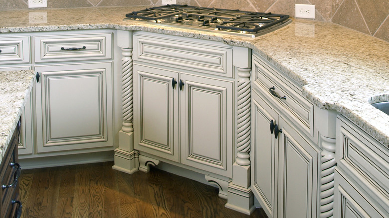 Ornate kitchen cabinets with raised panels, rope pillars and carved edges