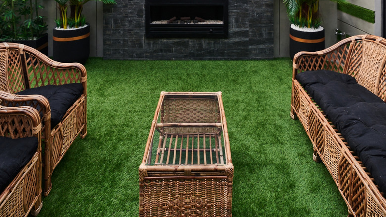 Outdoor wicker furniture sitting on artificial turf