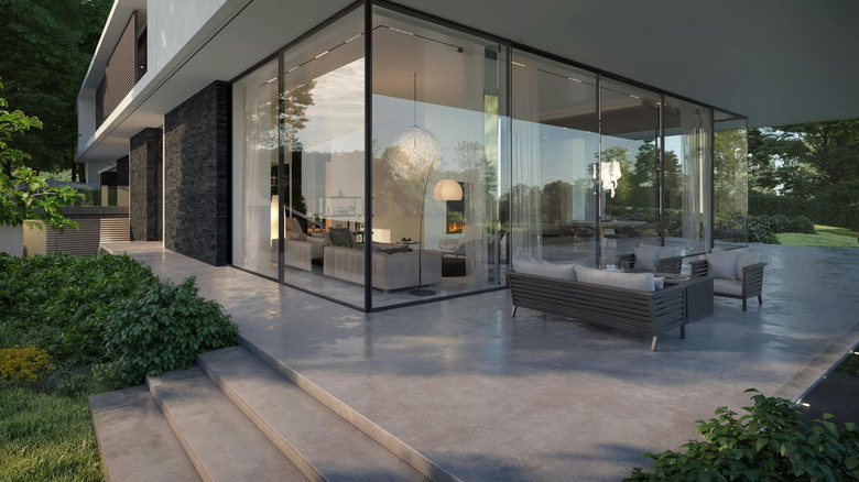 Home with concrete patio and steps with very angular, straight lines