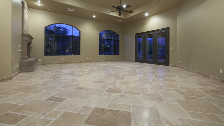 Empty living room with travertine flooring tiles