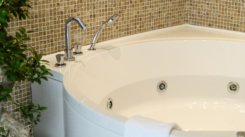 A white jet bathtub in bathroom.
