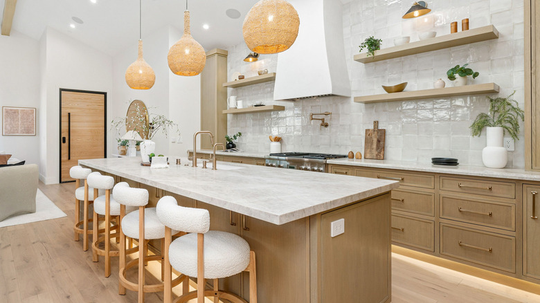 A kitchen with open shelves instead of upper cabinets.