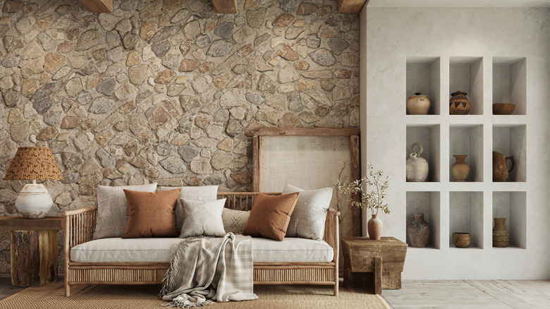 A living room with a stone accent wall.