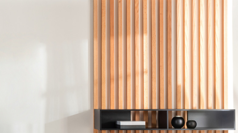 Wood slats on a wall with a floating shelf.