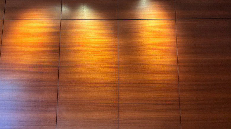 Wall panels covered in wood-style wallpaper.