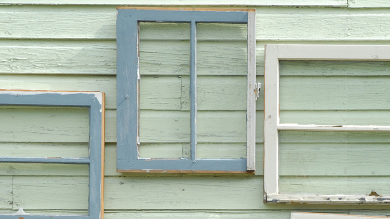 Old white and blue mirrors on exterior wall