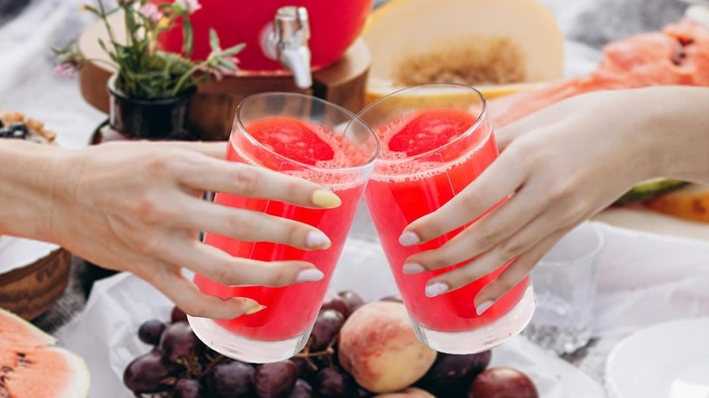 Two hands toasting with Réalwáy's Shatterproof Acrylic Tumblers
