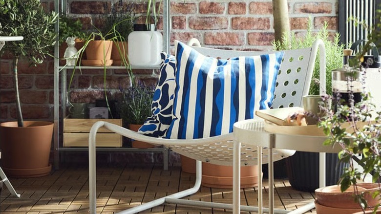 Blue and white cushions on a white outdoor chair