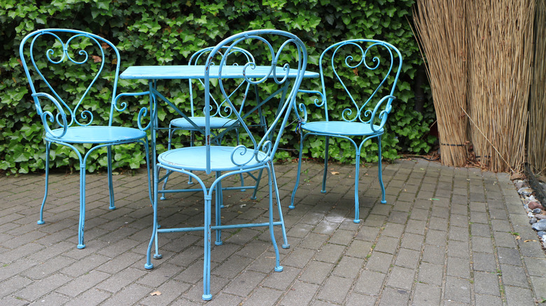 An iron patio set painted a baby blue