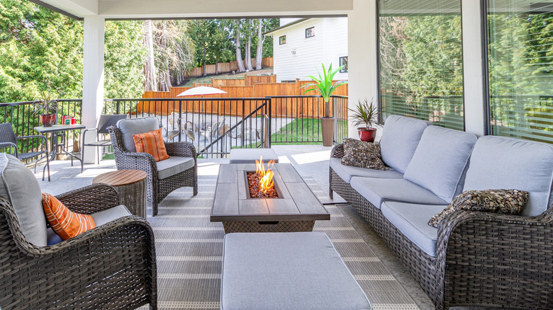 A stylish spacious deck with firepit table heater