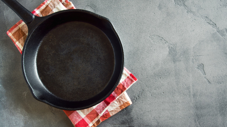 Close up of cast iron skillet on red checkered cloth