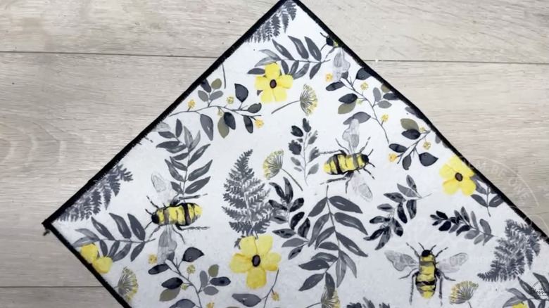 Bee design dish drying mat on a shelf in a Dollar Tree store.