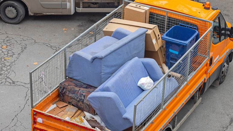 Old furniture in a trash truck
