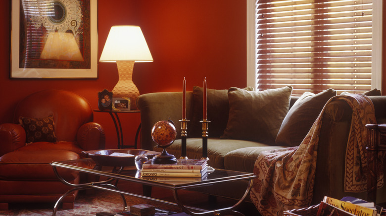 A dark living room with bright red walls