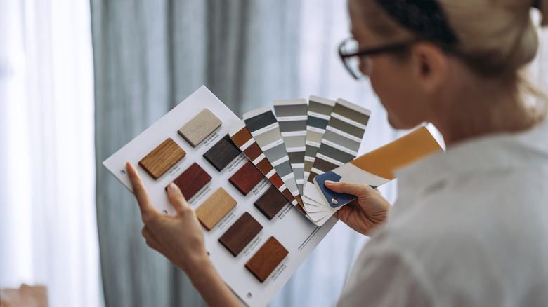 Person picking out paint colors