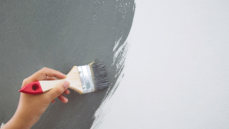 Person painting wall
