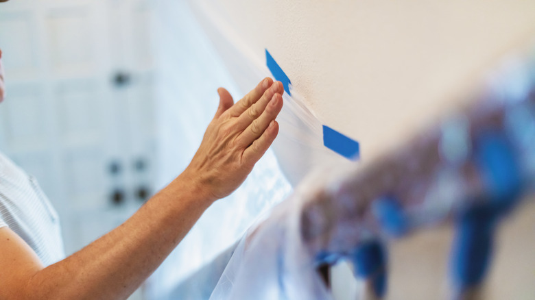 Person taping wall