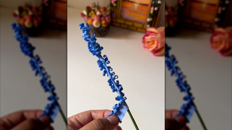 Person making paper lavender flower