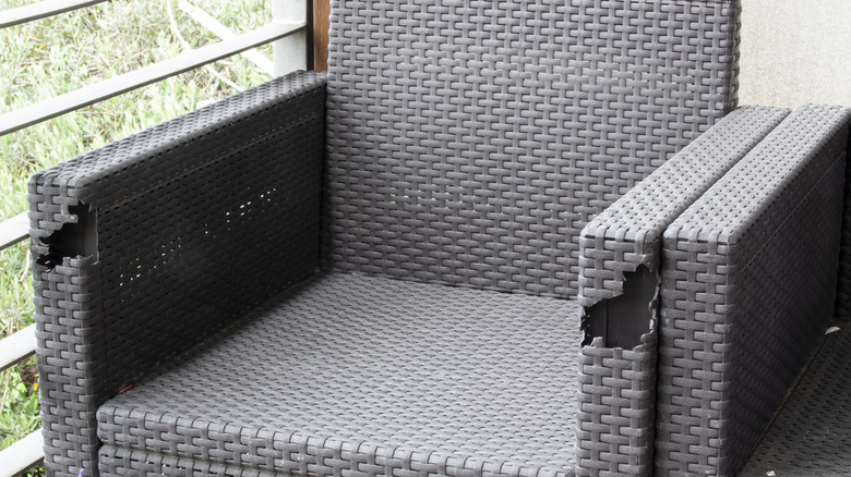 A cheap wicker outdoor chair with holes in it.