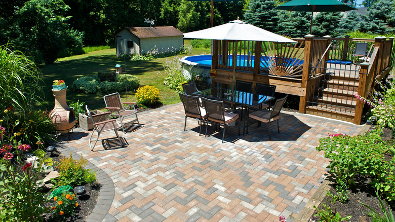 An intimate patio area surrounded by lush, green growth.