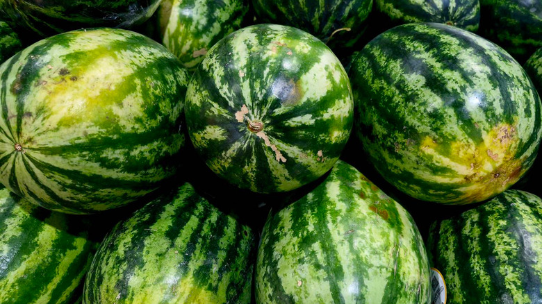 Watermelons are stacked on top of each other