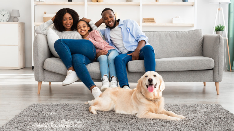 Family with dog on carpet