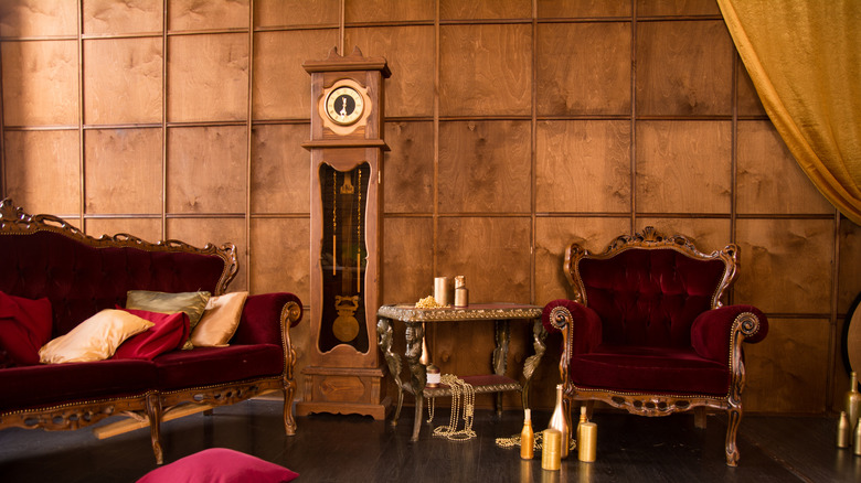 A room with red velvet furniture and gold accents