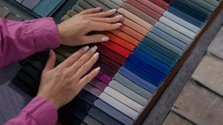Someone looking at velvet fabric swatches