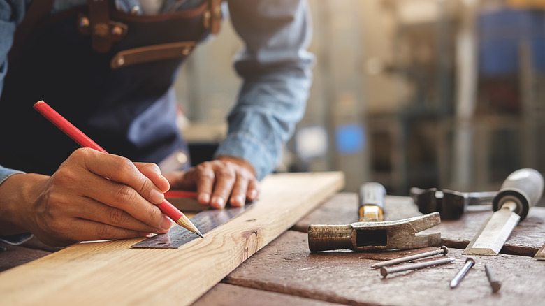 man building something from wood