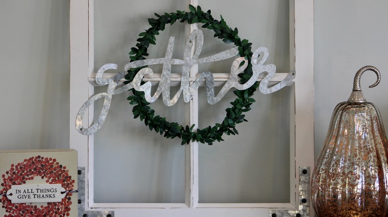wall hanging that says "gather"