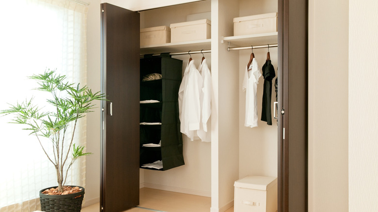 A clean closet with open bifold doors