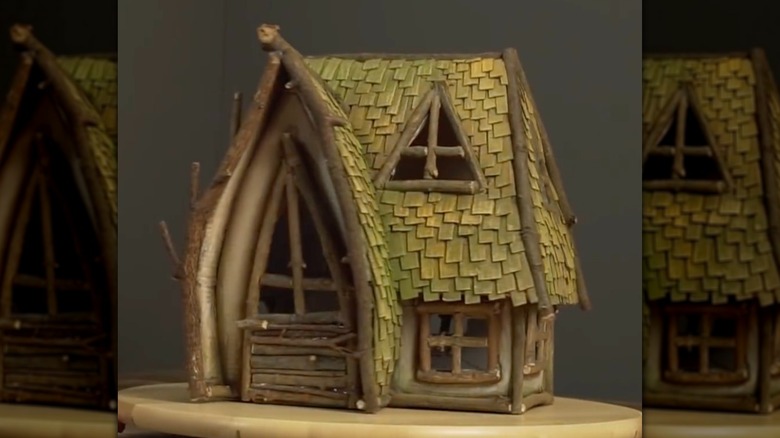 Fairy house created from cardboard, twigs, and paint.