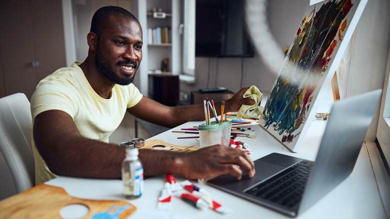 artist looking at a laptop