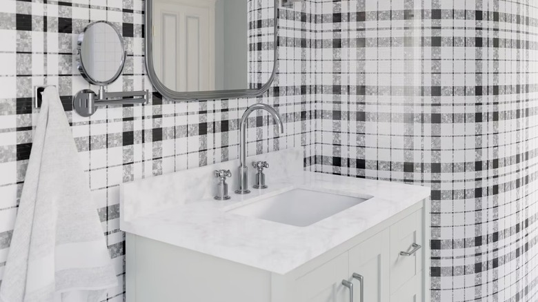 A modern bathroom with black and white plaid tiles on the walls