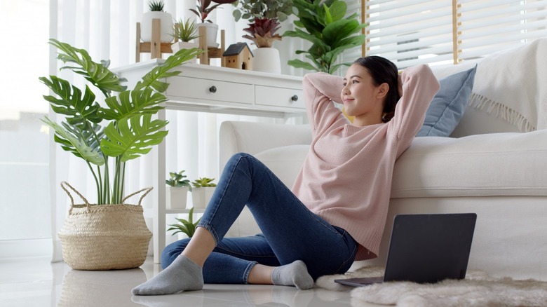 Woman in apartment with plants 