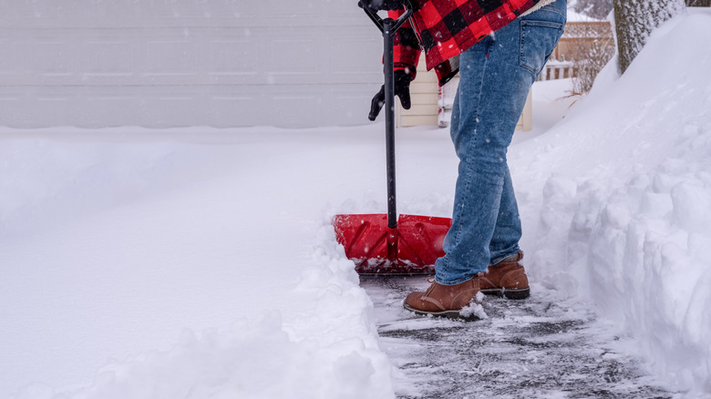 Man shoveling snow from driveway