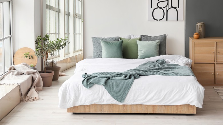 low platform bed with white bedding