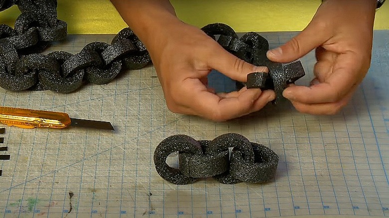 Woman making pool noodle chain