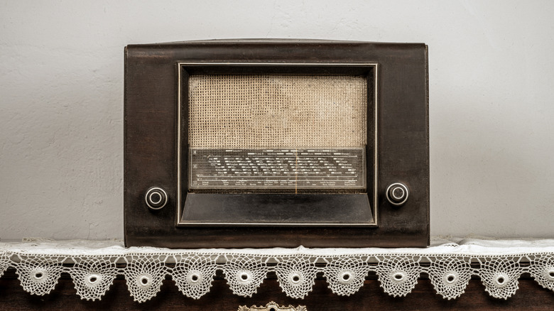 A retro radio sitting on a doily