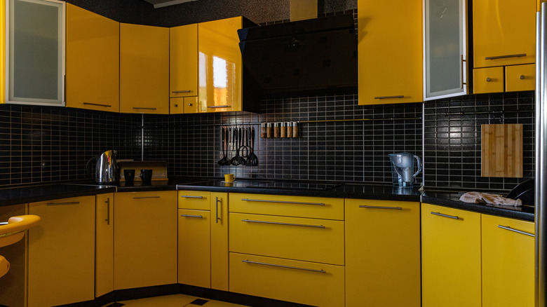 A contemporary kitchen with red cabinets.