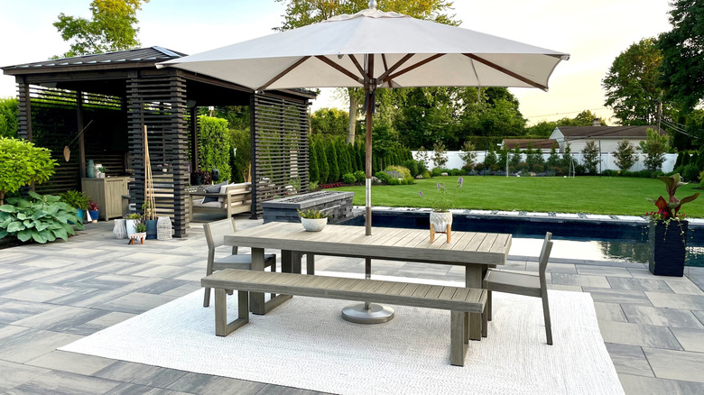Outdoor living space with pergola and dining set.