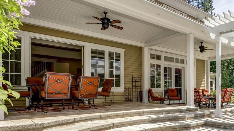 An outdoor porch with varied seating options for summer and winter