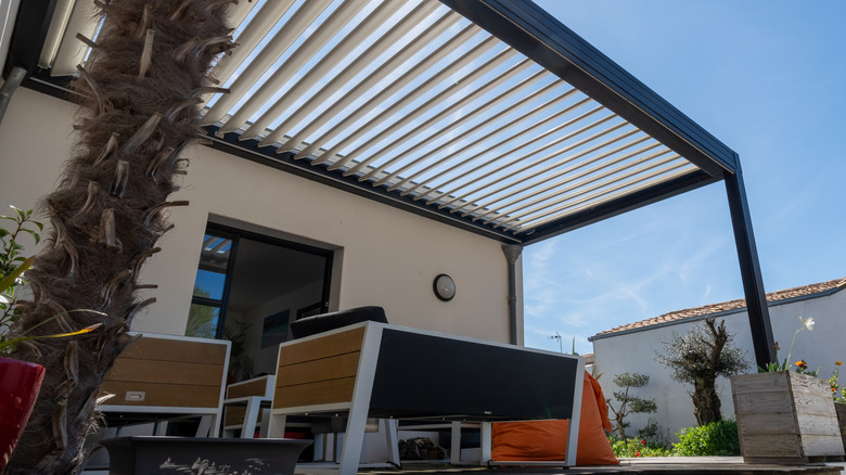 Black-painted slatted pergola on back porch