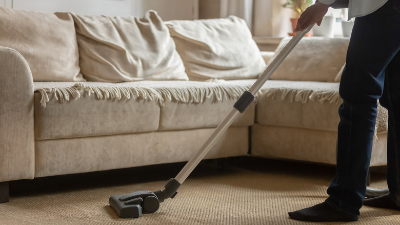 Person vacuuming carpet