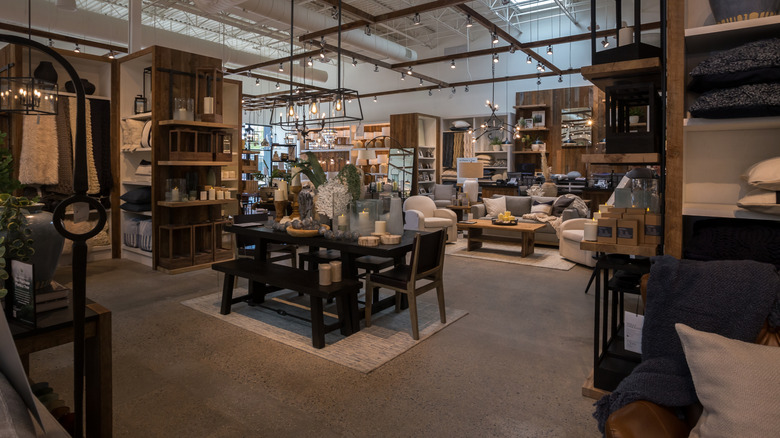 The inside of a Pottery Barn with wood furniture and decor