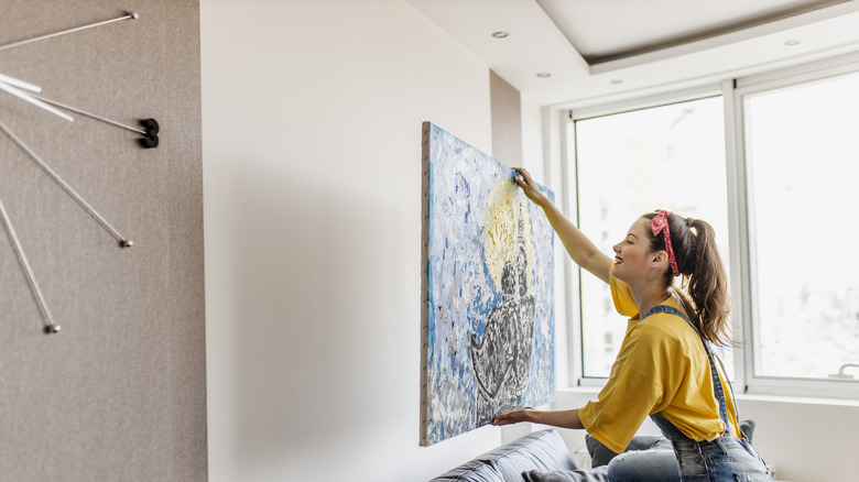 Person decorating a wall